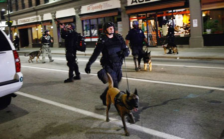 PITTSBURGH - SEPTEMBER 25: Riot police clear the streets after a protest against the G-20 Summit early on September 25, 2009 in Pittsburgh, Pennsylvania. Riot police with attack dogs turned out in force to quell the protest.